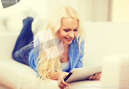 Image of smiling woman with tablet pc computer at home