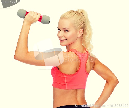 Image of young sporty woman with light dumbbell