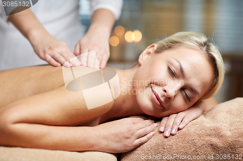 Image of close up of woman lying and having massage in spa