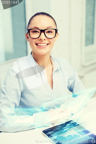 Image of smiling businesswoman in eyeglasses with tablet pc