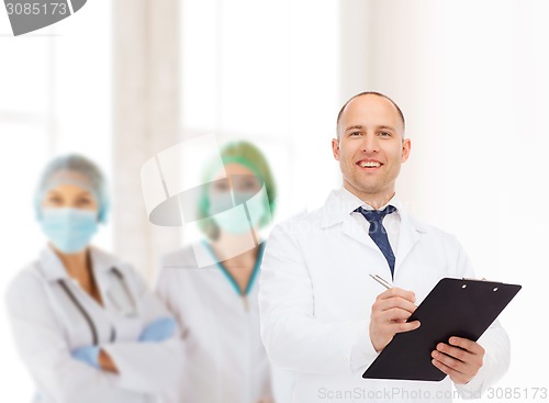 Image of smiling male doctor with clipboard