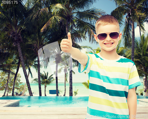 Image of smiling little boy over green background