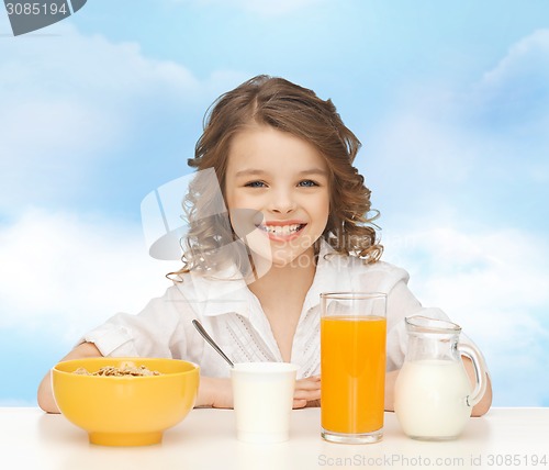 Image of happy girl eating healthy breakfast