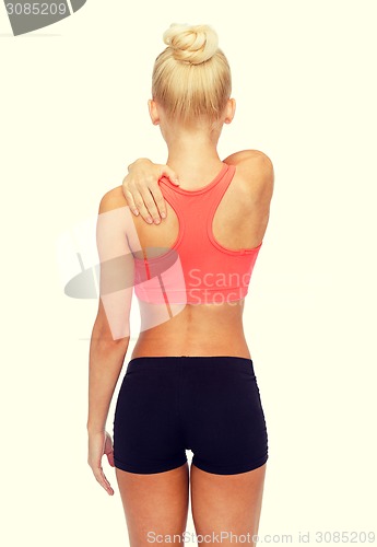 Image of sporty woman touching her shoulder
