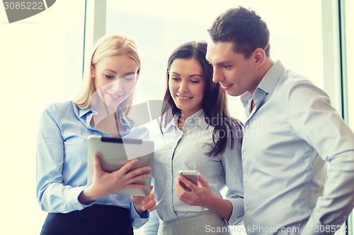 Image of business team working with tablet pcs in office