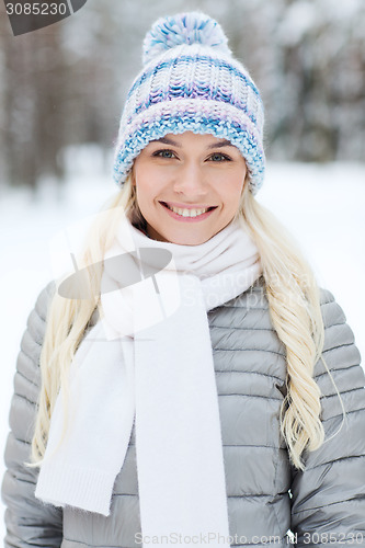 Image of smiling young woman in winter forest