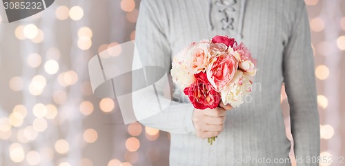 Image of close up of man holding flowers