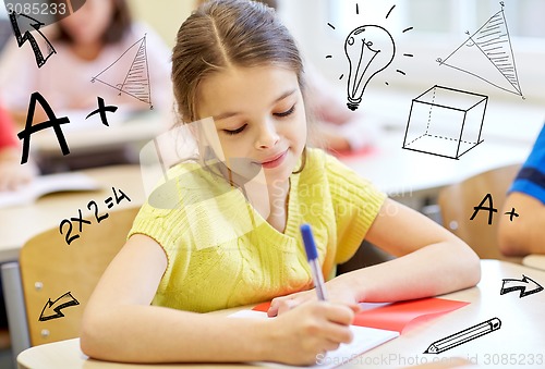 Image of group of school kids writing test in classroom