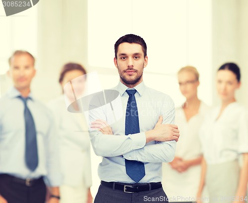 Image of handsome businessman with crossed arms