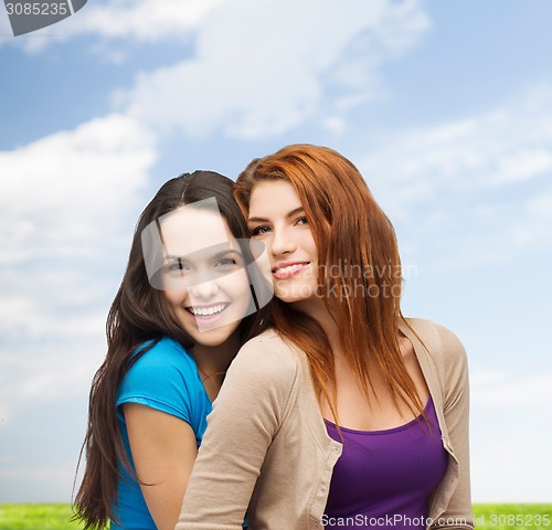 Image of smiling teenage girls hugging