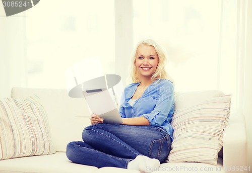 Image of smiling woman with tablet pc computer at home