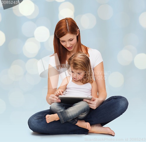 Image of happy mother with little girl and tablet pc