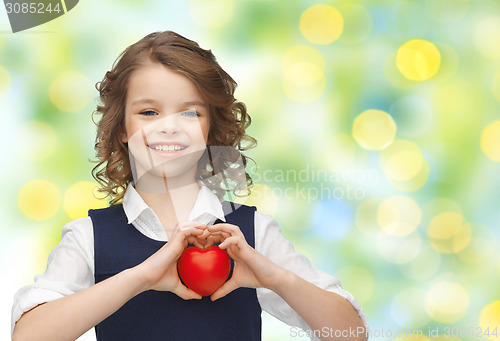 Image of smiling little girl with red heart