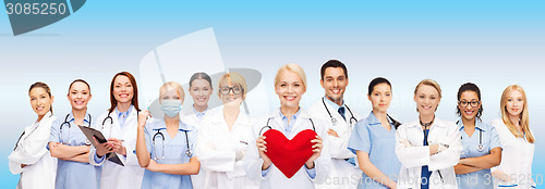 Image of smiling doctors and nurses with red heart