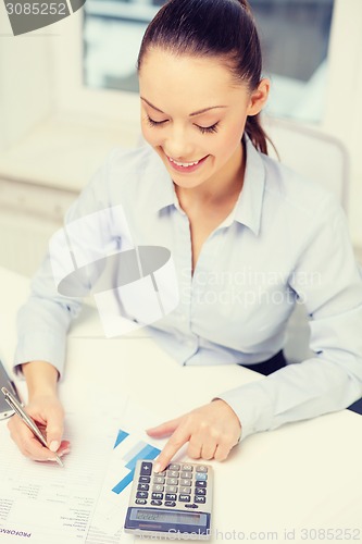 Image of businesswoman working with documents in office