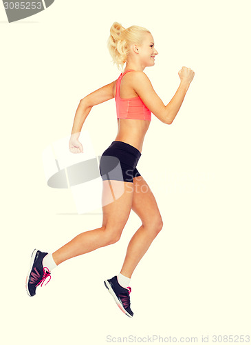 Image of sporty woman running or jumping