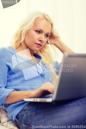 Image of woman with laptop computer at home