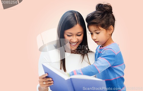 Image of happy mother and daughter reading book