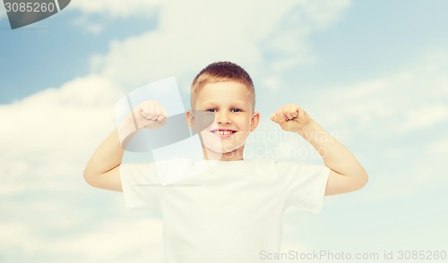 Image of happy little boy in white t-shirt flexing biceps