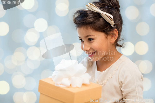 Image of happy little girl with gift box