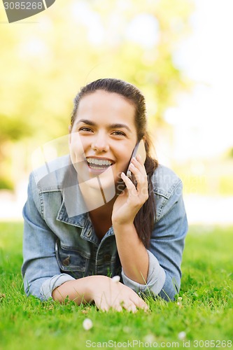 Image of laughing young girl lying on grass
