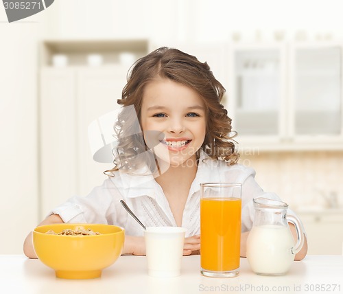 Image of happy girl eating healthy breakfast