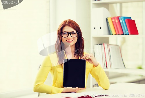 Image of smiling student girl in eyelgasses with tablet pc