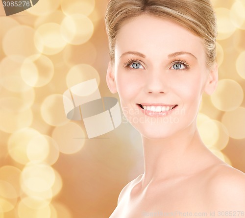 Image of close up of smiling woman over beige background