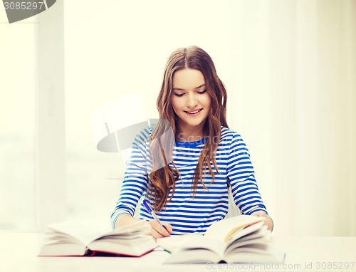 Image of happy smiling student girl with books