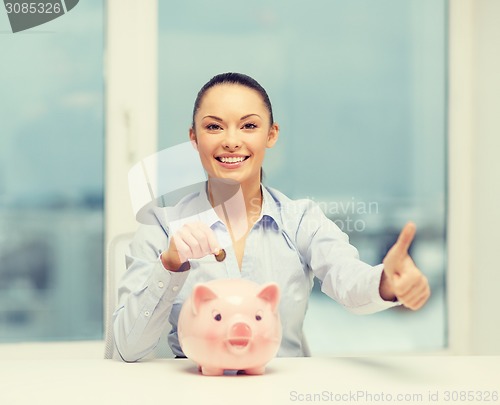 Image of smiling woman with piggy bank and cash money