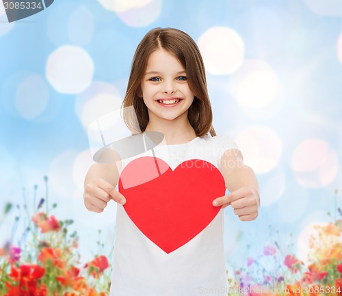Image of smiling little girl with red heart