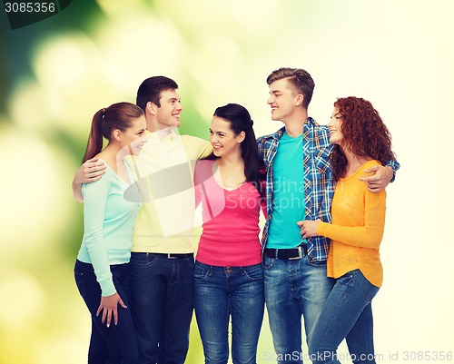 Image of group of smiling teenagers over green background