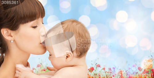 Image of happy mother with baby over natural background