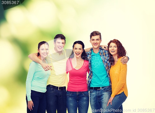 Image of group of smiling teenagers over green background