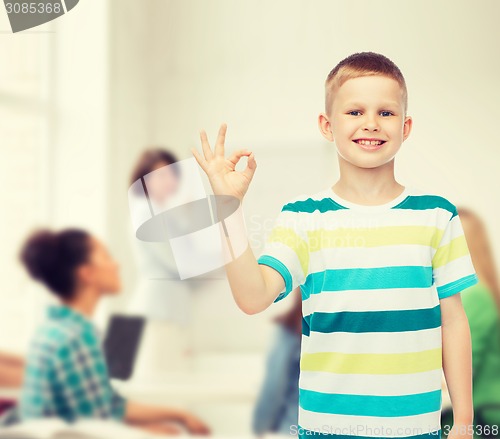 Image of little boy in casual clothes making ok gesture