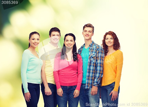 Image of group of smiling teenagers over green background