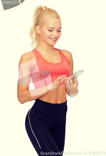 Image of smiling sporty woman with smartphone