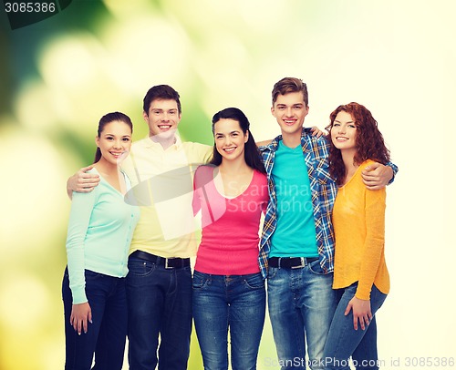 Image of group of smiling teenagers over green background