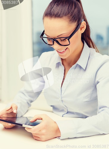 Image of smiling businesswoman in eyeglasses with tablet pc