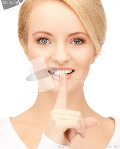 Image of happy woman with finger on lips