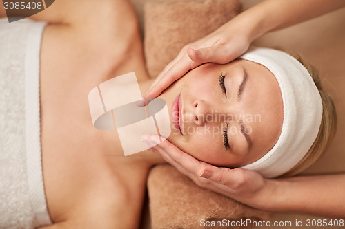 Image of close up of young woman having face massage in spa