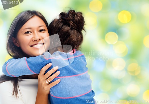 Image of happy mother and daughter hugging