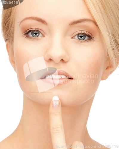 Image of beautiful woman pointing to chin