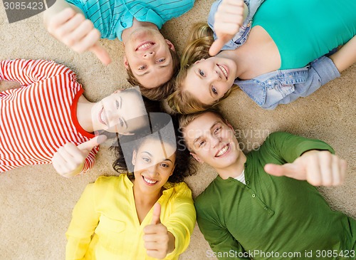 Image of group of smiling people lying down on floor