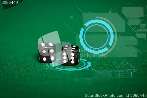 Image of close up of black dice on green casino table