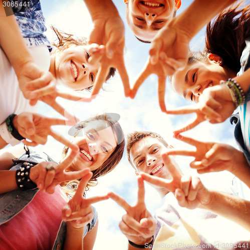 Image of group of teenagers showing finger five