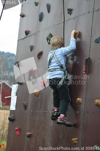 Image of Boy climbing a wall