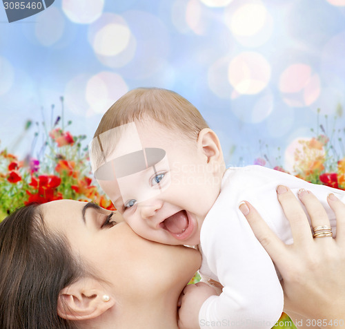 Image of happy mother with baby over natural background