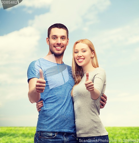 Image of smiling couple showing thumbs up