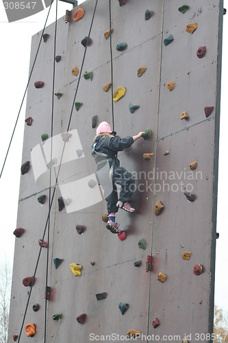 Image of Girl climbing a wall